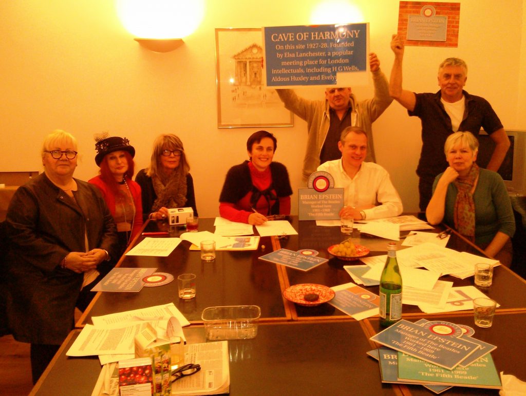 members of the Trust's Plaque Group sitting around a table, with sample plaque designs
